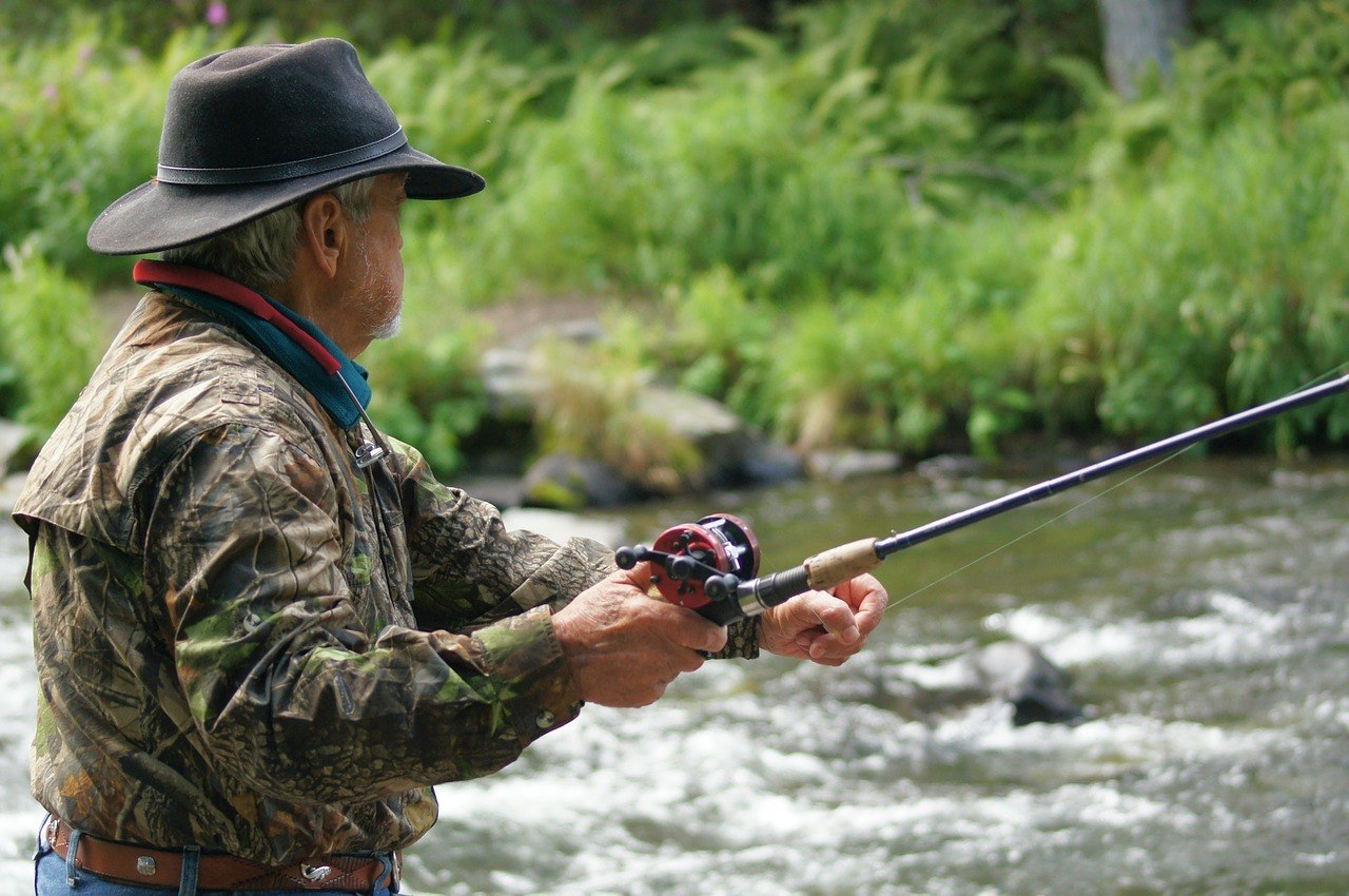 man fishing using one of the best sage fly rods